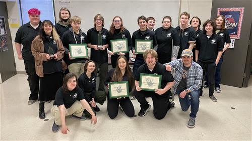 MMT students pose with awards certificates 